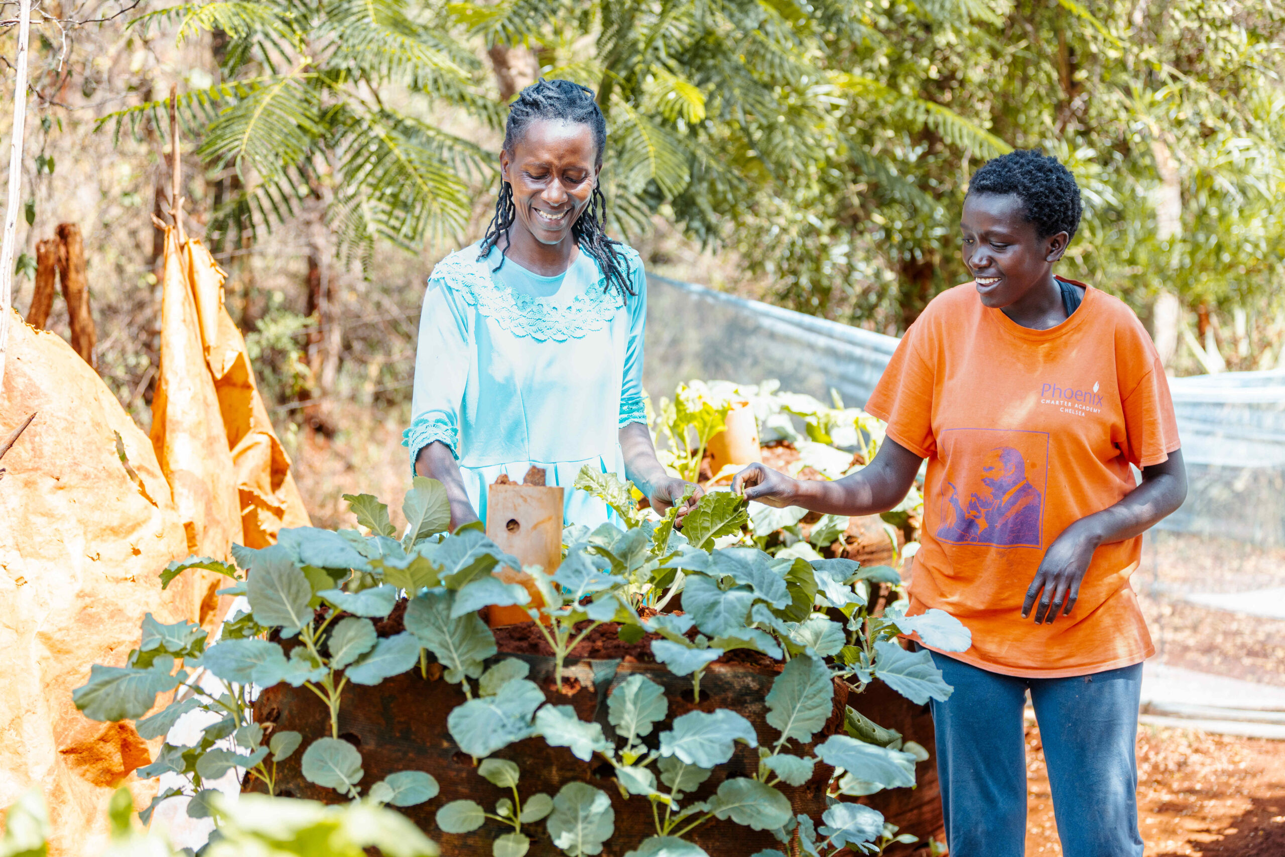Wendy (left) and her daughter admiring the vegetables in their vertical garden.
