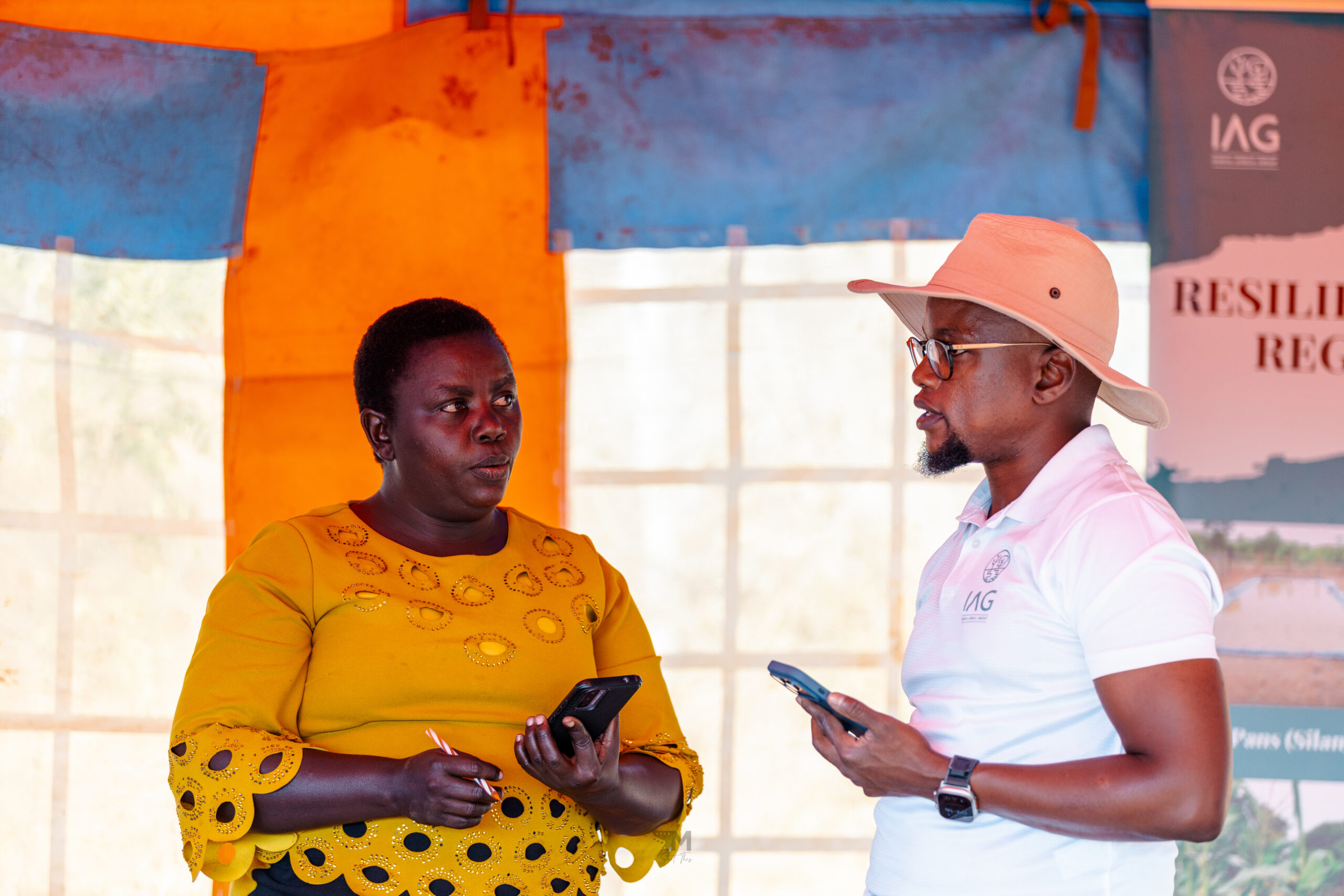IAG founder Samuel Vaita (right), speaking to one of the farmers we work with, Pauline.