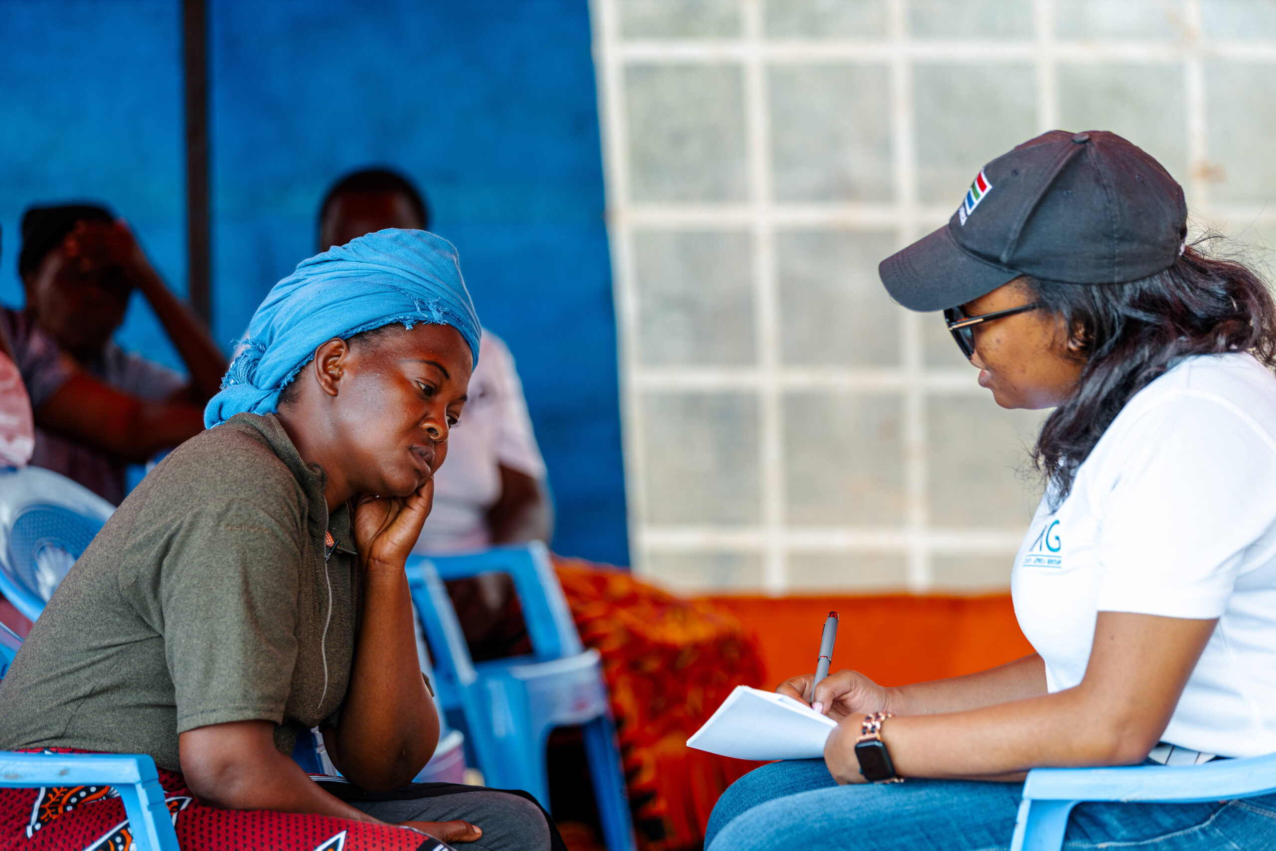IAG co-founder Ashley Mutiso (right) speaking with a local farmer from Machakos .