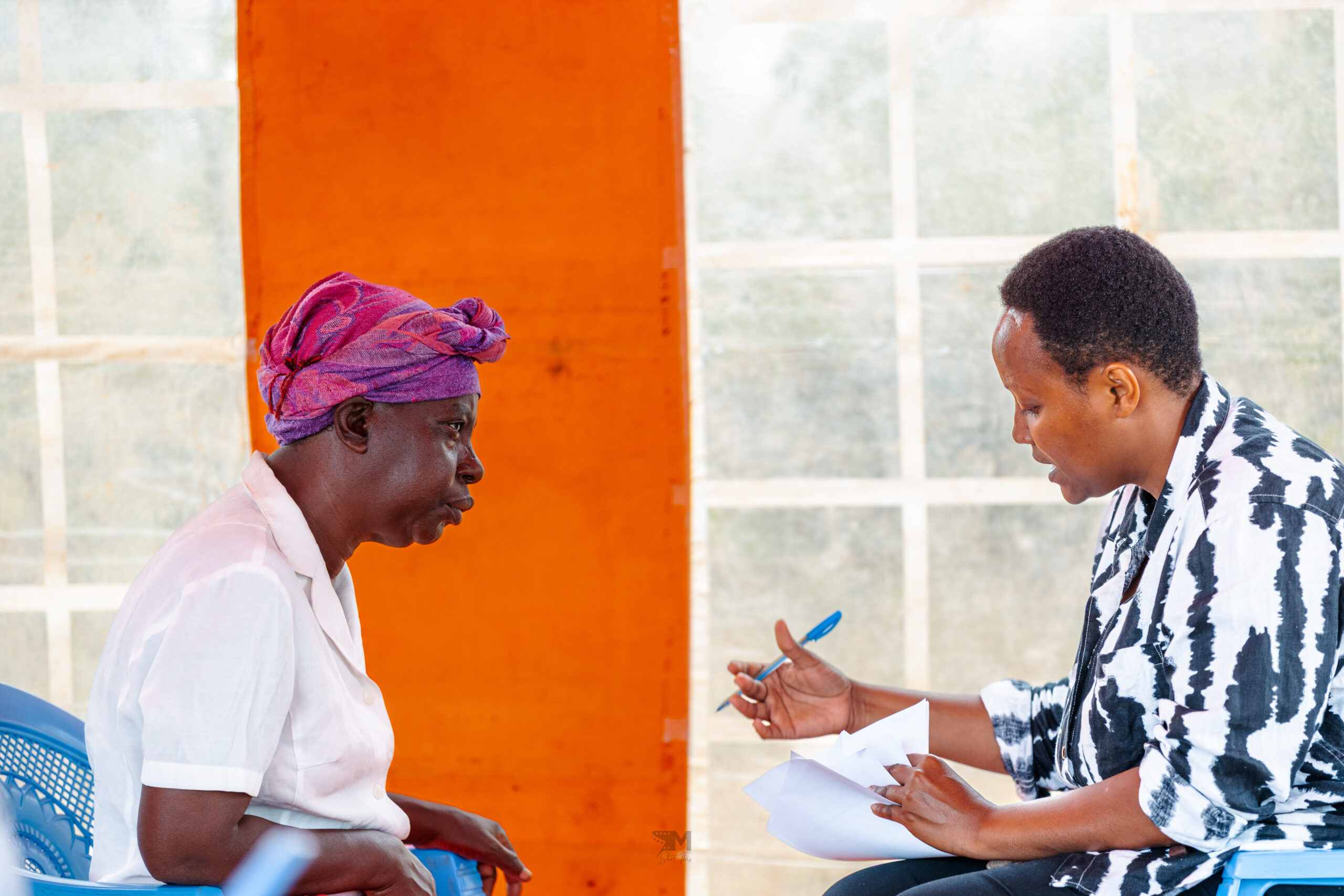 IAG Research and ESG Consultant, Caroline Ndaama, (right) speaking to a smallholder farmer from Machakos during a research exercise collecting data from local farmers on what challenges they face and how to best address them