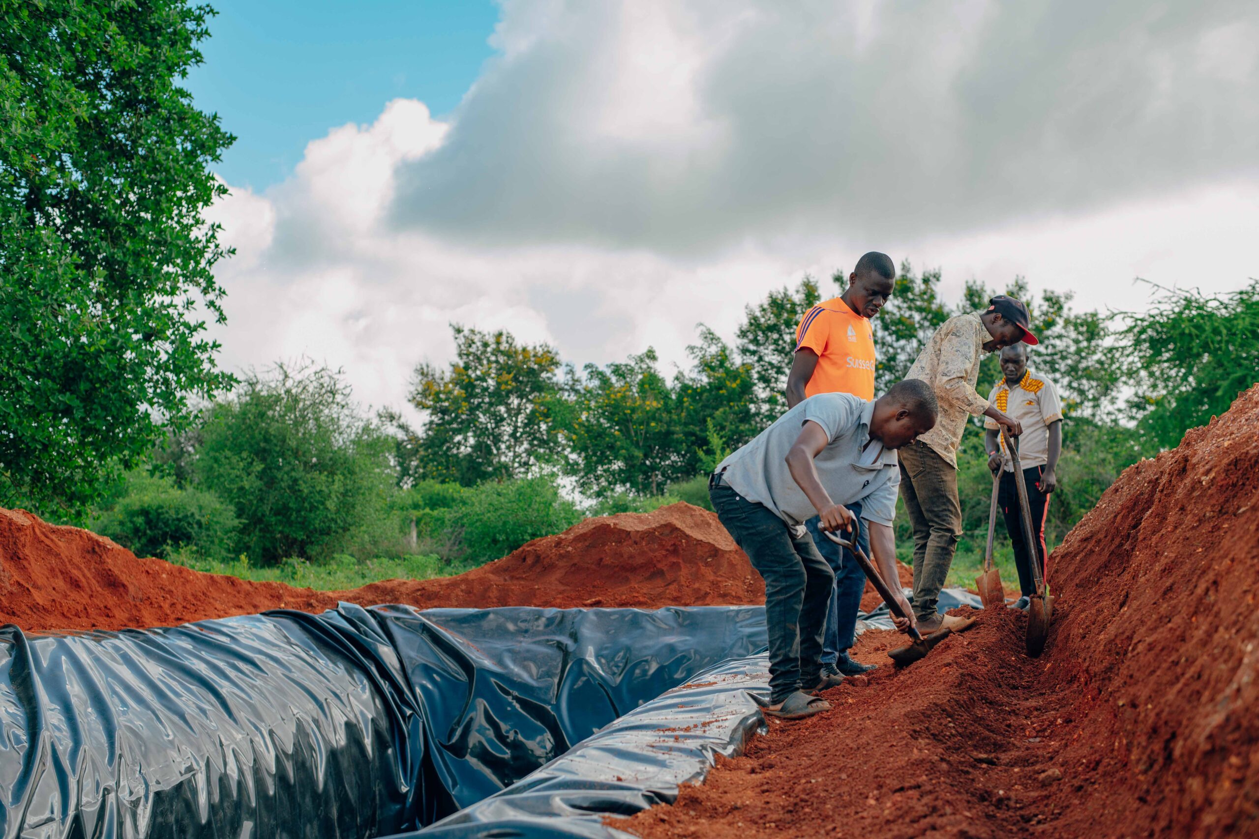Young men from Machakos hard at work constructing a water pan.