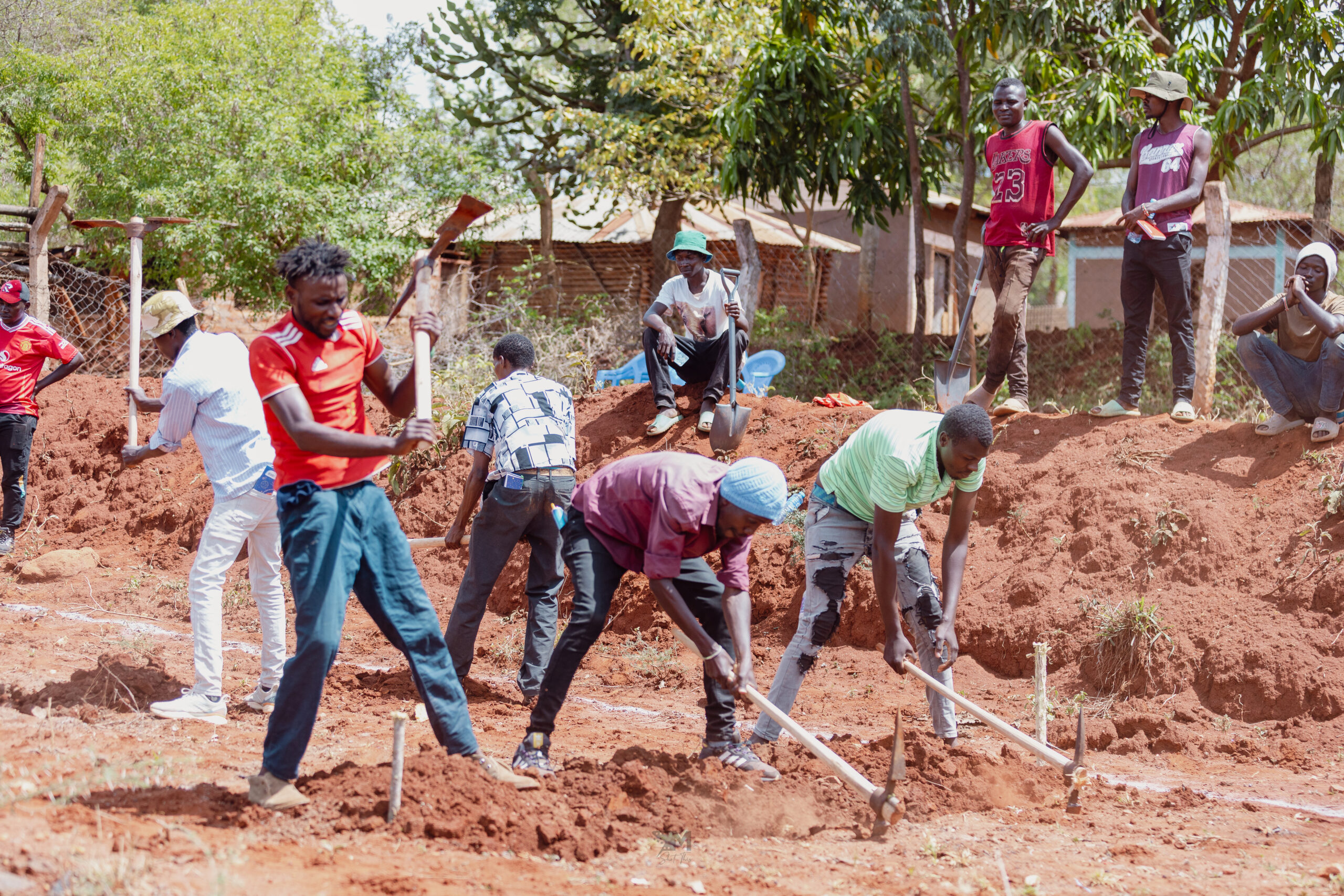 Young men from Machakos setting the foundation for the construction of a water pan.