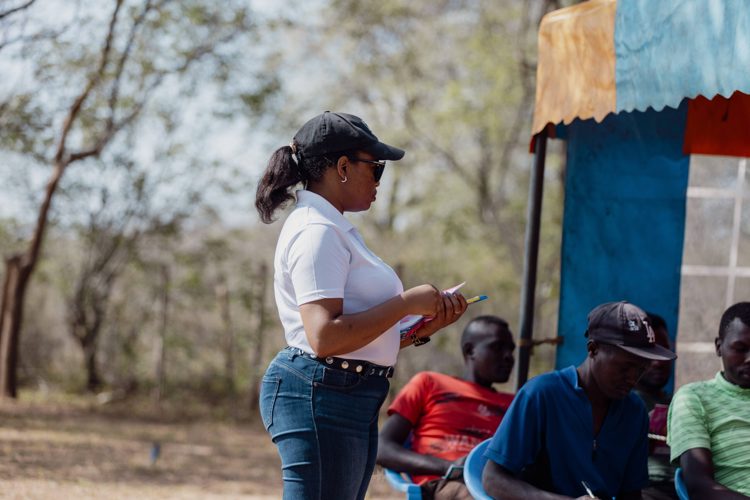 IAG co-founder Ashley Mutiso (left) interacting with local young men during a training on how to construct water pans in Machakos.