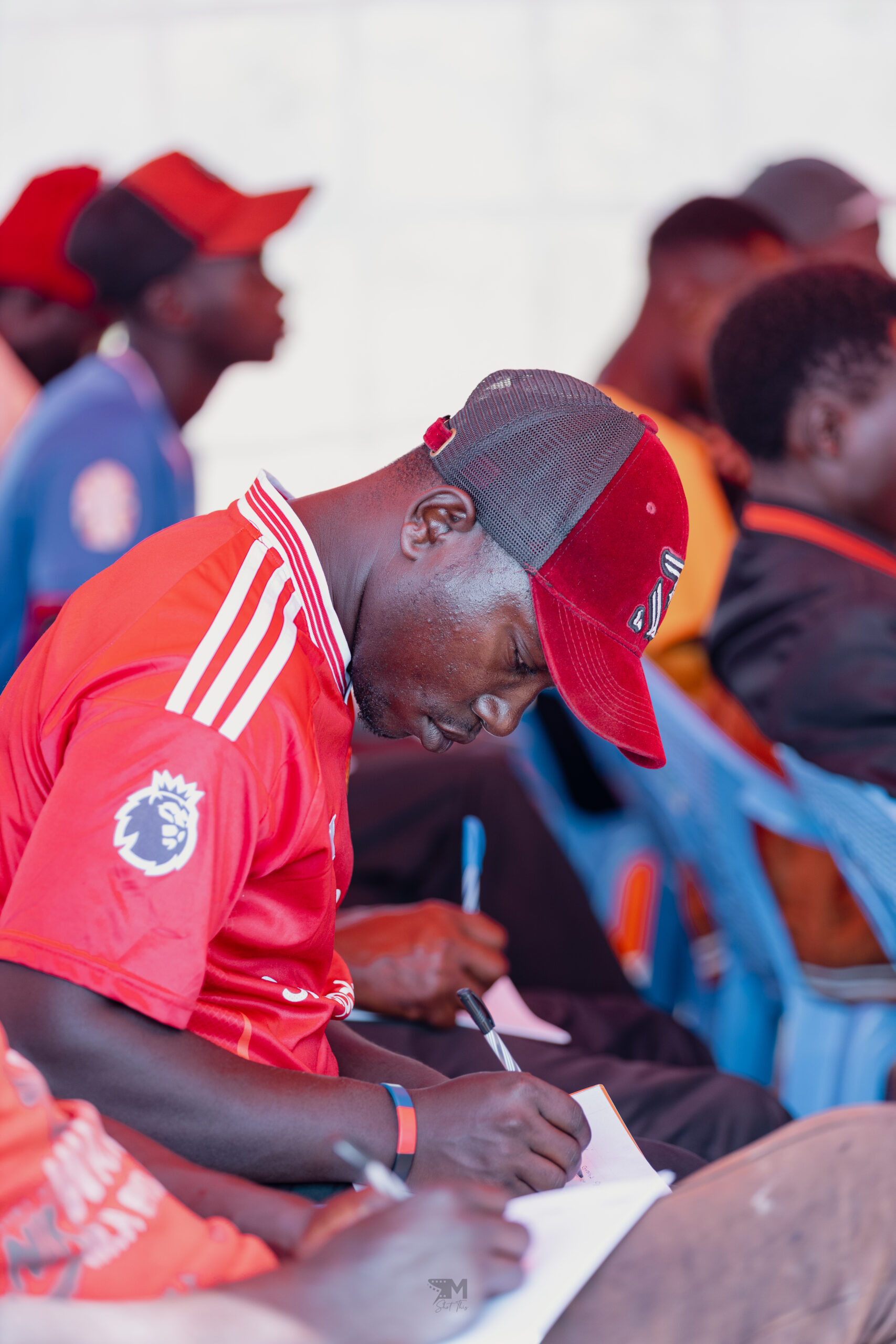 One of the young men who attended our training on water pan construction keenly taking notes.